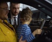 Get 100&#39;s of FREE Video Templates, Music, Footage and More at Motion Array: http://bit.ly/2SITwWM nnnGet this here: https://motionarray.com/stock-video/family-checking-out-new-car-153193nnThis is a delightful shot of a family checking a brand new car in a showroom. They are a bit unsure of what to buy so the consultant decided to show them this option. The toodler plays around in the car, stirring the wheel like he is playing a racing game in an arcade. Use this for commercials, films, dramatiza