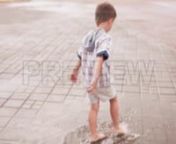 Get 100&#39;s of FREE Video Templates, Music, Footage and More at Motion Array: http://bit.ly/2SITwWM nnnGet this here: https://motionarray.com/stock-video/barefoot-puddle-jummping-252048nnThis stock video features a barefoot boy plays in a puddle on a city street.