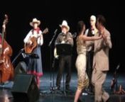 Annie Trimble sings the traditional and iconic Cajun song “Jolie Blon” in French-based pidgin, or creole language while Steve Conrad and Lacey Maynard waltz to the music of Doc Rolland’s Americana String Ensemble in its China tour. The 9-piece acoustic band plus two dancers and an interpreter gave 24 concerts at major civic venues throughout China in August 2014. The program featured fiddling, cowboy, country, Celtic, Cajun, swing, bluegrass and old-time music. Traveling by bus, bullet tra