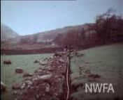 Extract from a BBC NW programme first broadcast in June 1977.nnExtracts from a programme about the introduction of electricity to the remote valley of Wasdale Head in Cumbria.A brief history of Wasdale is given, describing it as the birthplace of rock climbing in the 1880s.The narrator describes the conflict surrounding the decision to bring electricity to the valley and there are shots of Norweb workers laying cables.Fell running champion and Wasdale sheep farmer Joss Naylor and his wife