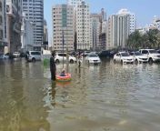 Sharjah residents use inflatables to wade through the water from water water falls
